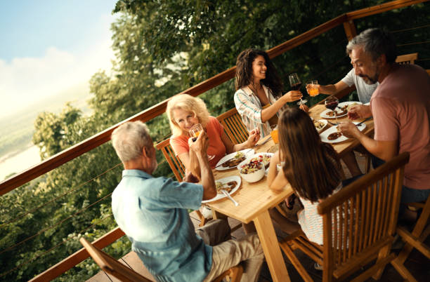 istock Family having dinner at a weekend house. 2110235441