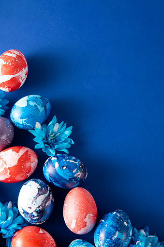 Colorful dyed easter eggs on blue background