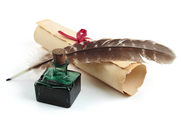 istock Feather with old scroll and inkwell isolated on a white background 2110261577