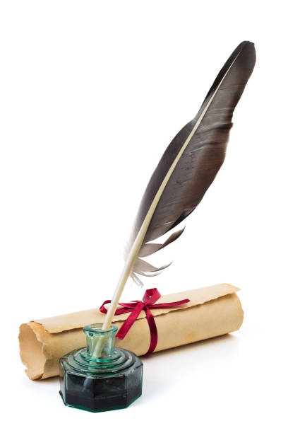 Ancient paper scroll with feather and ink bottle isolated on a white background
