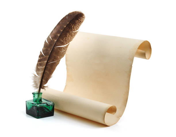 istock Old scroll or parchment with feather and ink bottle isolated on white background 2110274643