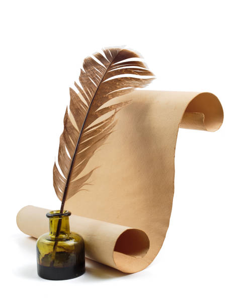 istock Ancient paper scroll with feather and ink bottle isolated on a white background 2110274645