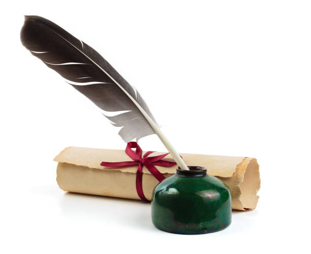 istock Old scroll or parchment with feather and ink bottle isolated on white background 2110281634