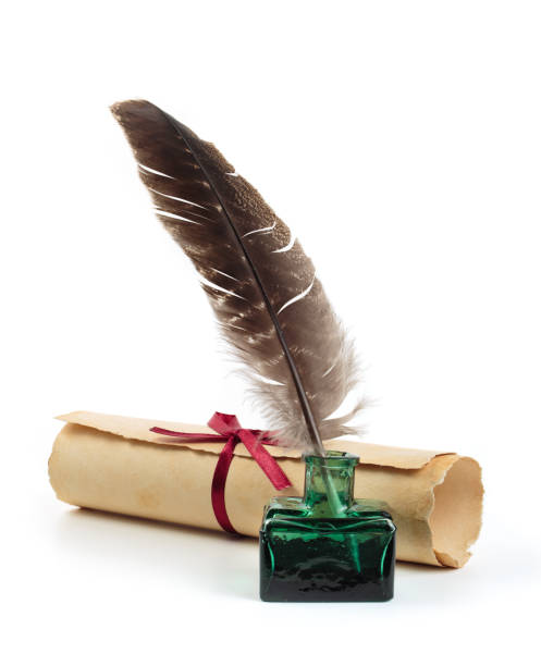 Ancient paper scroll with feather and ink bottle isolated on a white background