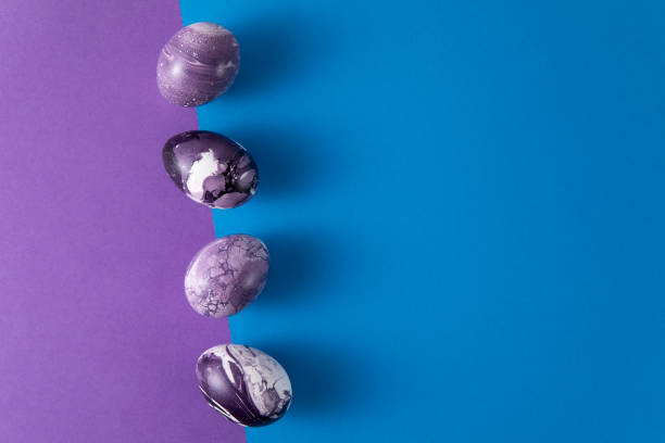 istock Easter Eggs on Blue and Purple Background 2110307051