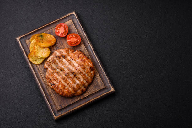 istock Delicious fresh grilled chicken fillet with spices and herbs 2110321159