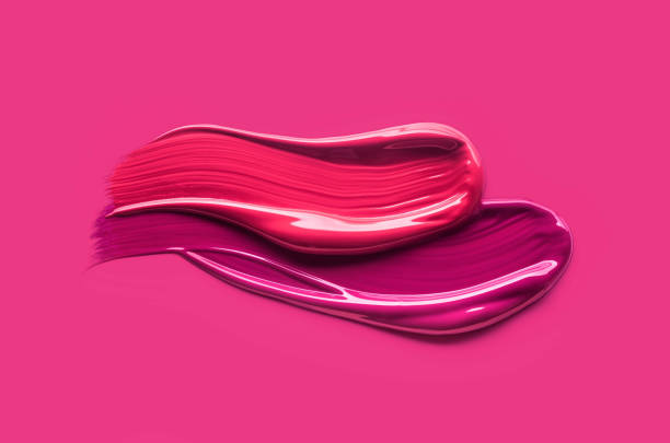 istock Lip gloss palette purple red color smudge sample isolated on pink background 2110324282