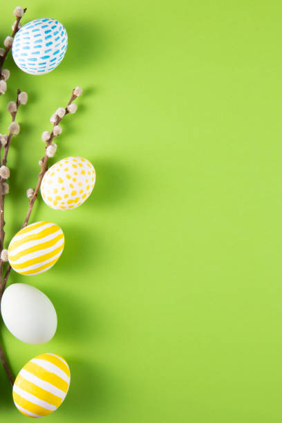 istock Flowers and Coloured Easter Eggs on Light Green Background 2110347431