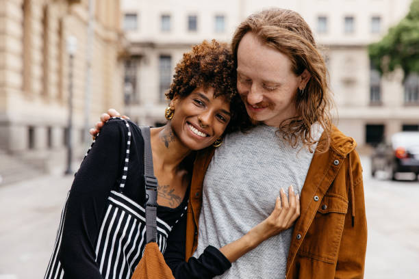istock Affectionate embrace on the city streets with smiling couple 2110347436