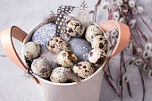 a plate with fluffy feathers and Easter quail eggs. Easter Holiday