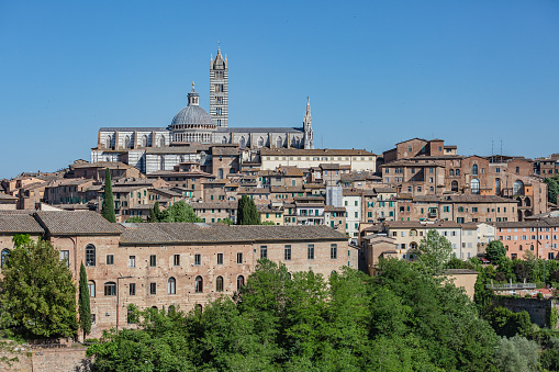 Panoramic view of Siena, the Dome and Bell Tower of Siena Cathedral (Duomo di Siena), ancient houses.
