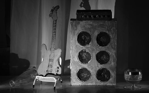 Grungy cardboard models of bass guitar and amplifier,music,performance,instruments concept,black and white
