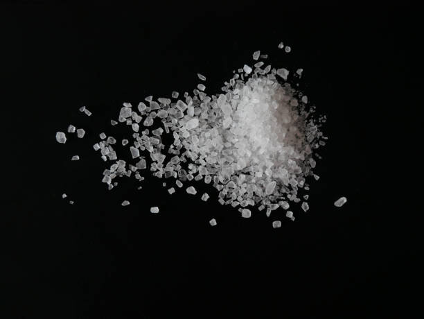 istock Coarse sea salt crystals isolated on black background close up 2110396264