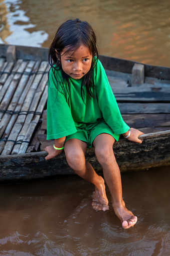 Cambodian girl on a boat in village near Tonle Sap, Cambodia