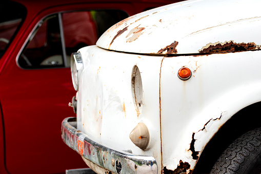 Old rusty destroyed car covered with rust, vintage car.