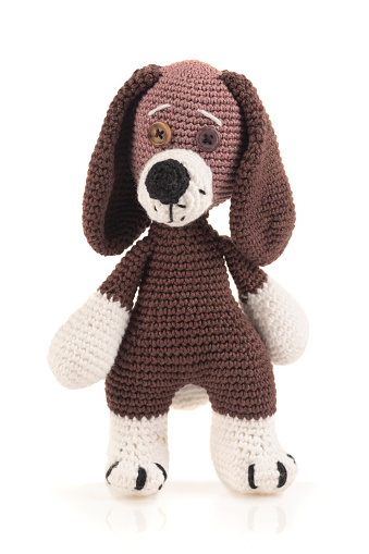 Handmade dog doll on white background