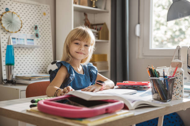 istock Schoolgirl studying at home 2110527156