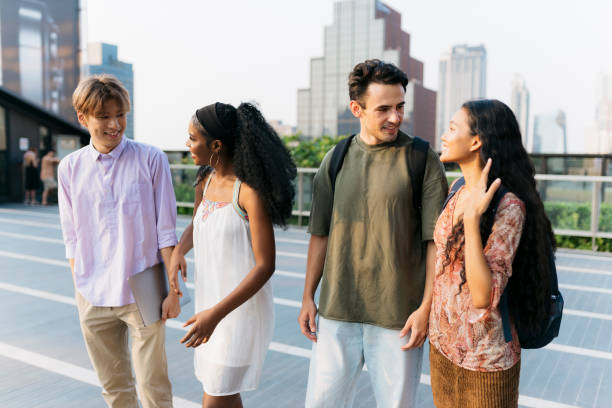 istock University students walking and talking outdoors 2110539537