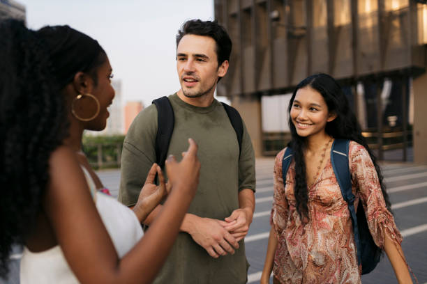 istock University students relax outside the college building 2110541591