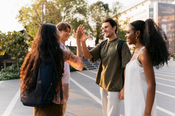 istock Group of students enjoy a moment outside the college 2110548702
