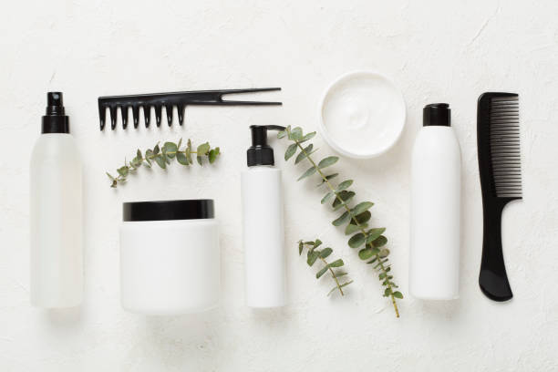 istock Professional hair care products with comb on concrete background, top view 2110549232
