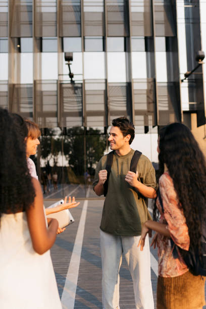 istock Group of friends hanging out on the university campus 2110550831