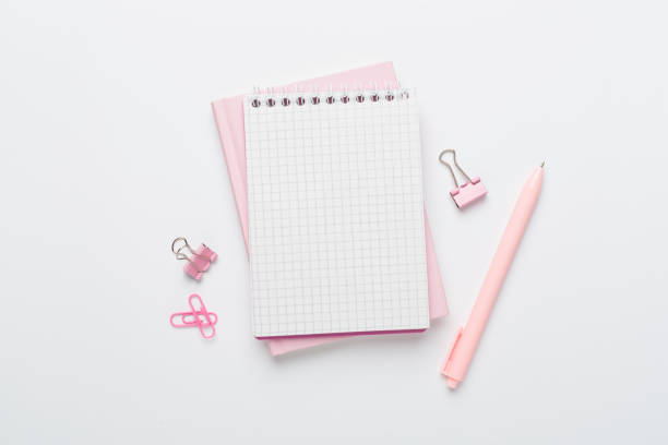 Notebooks with stationery on color background, top view