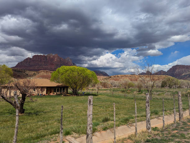 istock Irrigation Ditch and Orchard in Spring with Ford Ranch in background below Mt Kinesava in Zion National Park Utah 2110565664