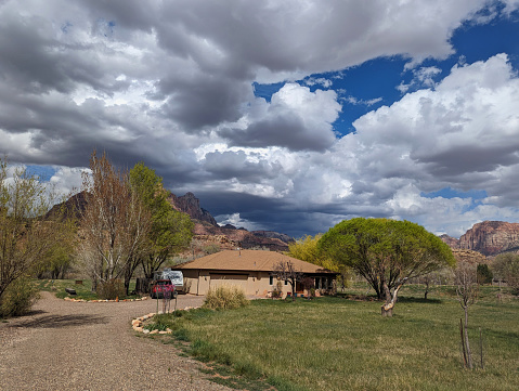 Irrigation Ditch and Orchard in Spring with Ford Ranch in background below Mt Kinesava in Zion National Park Utah