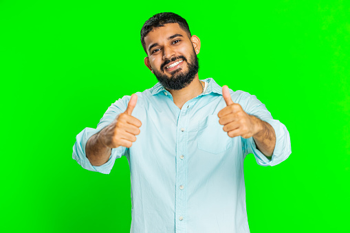 Like. Indian man raises thumbs up agrees with something or gives positive reply recommends advertisement likes good idea feedback, celebrating success victory. Guy isolated on chroma key background