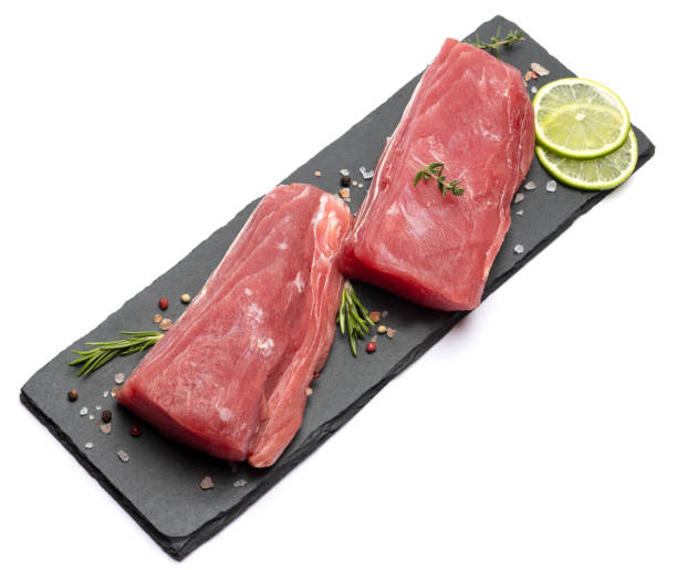 istock Fresh tuna Fish steak on stone serving board isolated on white background 2110617825