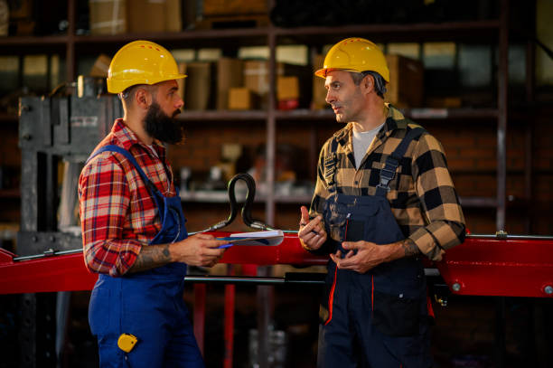 istock Mechanics exchanging new business ideas with each other in a workshop. 2110624545