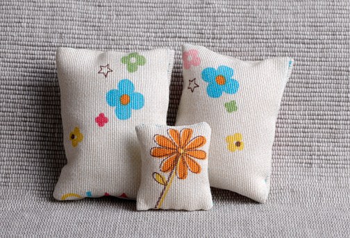 Cute cushions with colorful flowers on a sofa