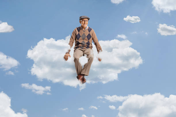 istock Male pensioner sitting on a cloud 2110770563