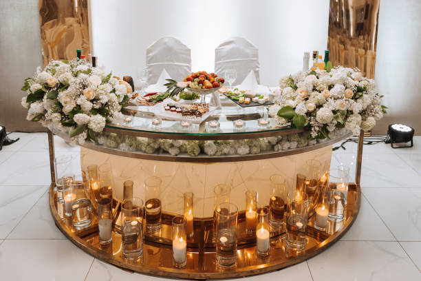 istock Romantic table setting in a restaurant for a holiday. Wedding decor for the newlyweds at the banquet. Floristry of fresh flowers and candles, boho style. Catering for the bride and guests. 2110772955