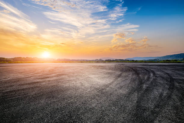 istock Empty racing road and mountains at sunset. Car road background 2110826820