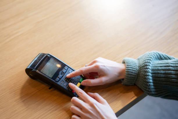 istock a Person Using Credit Card and enter the password on bank wireless terminal Reader 2110831523