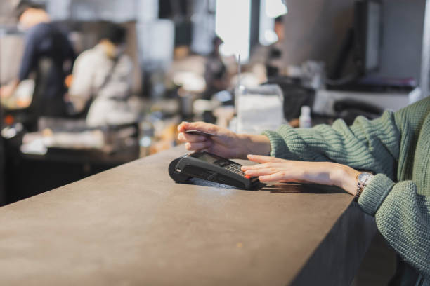 istock Customer Completing a Credit Card Transaction at a Retail Checkout 2110837790