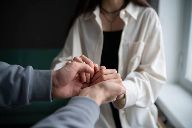 istock Two people engage in a compassionate touch, offering emotional support through a simple but powerful gesture of connected hands. 2110890285