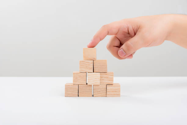istock Hand arranging wood block 2110905198
