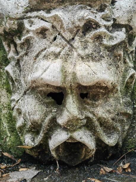 istock Close up of a man face statue in stone. 2110915918