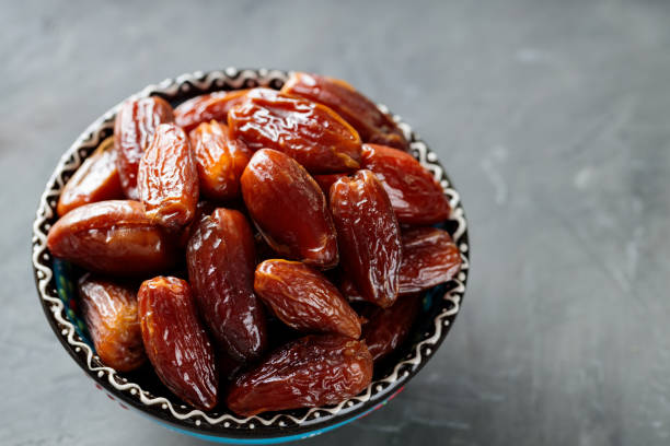 istock Medjool Dates Bowl on Dark Concrete, Healthy Ramadan Suhour Snack, Copy Space 2110924574