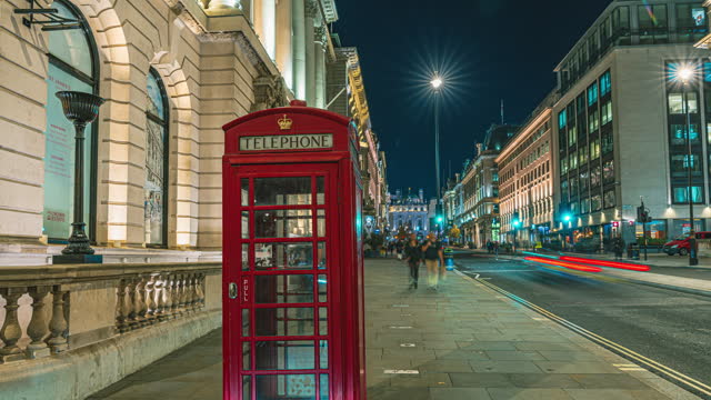 4K Footage night Time lapse of  Red Telephone booth with Crowded people Tourism walking and double-decker bus sightseeing at regent street and piccadilly circus area in London, England, United Kingdom