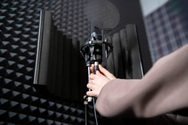 istock Musician Set Up plug in and adjust  Microphone in Soundproof Recording Studio 2111019792