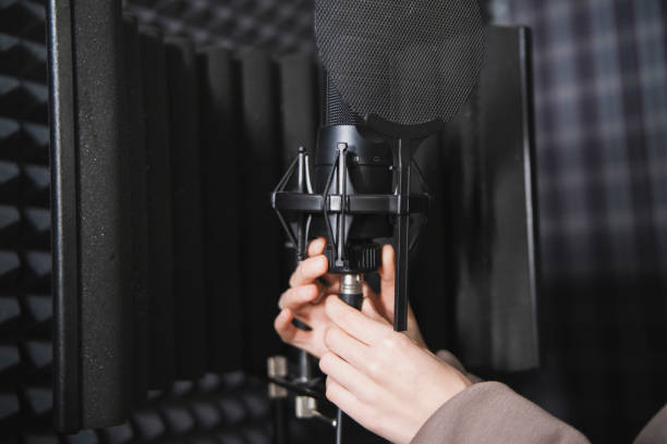 istock Musician Set Up plug in and adjust  Microphone in Soundproof Recording Studio 2111019896