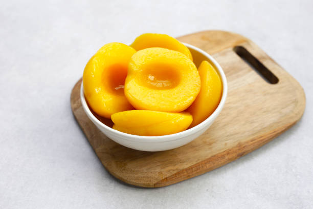 istock Peach halves in syrup. Fruity desserts 2111035360
