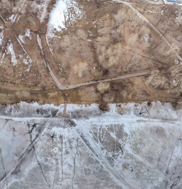 istock Ice melts on the river. Ice crack. Aerial drone view. Spring sunny morning. 2111036398