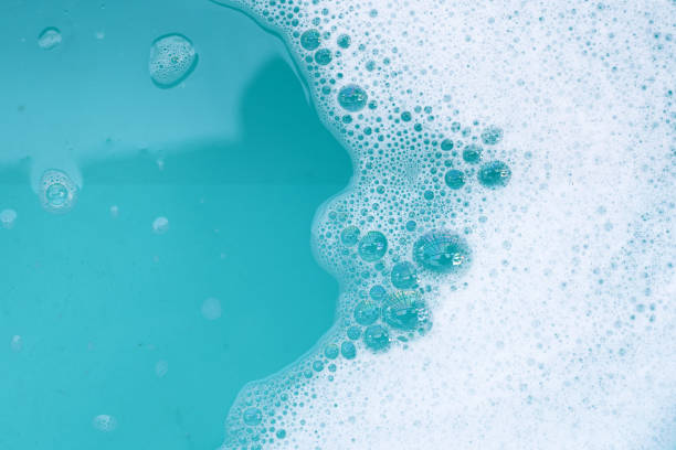 istock Detergent foam bubble on water. Blue background, Soap sud 2111038513