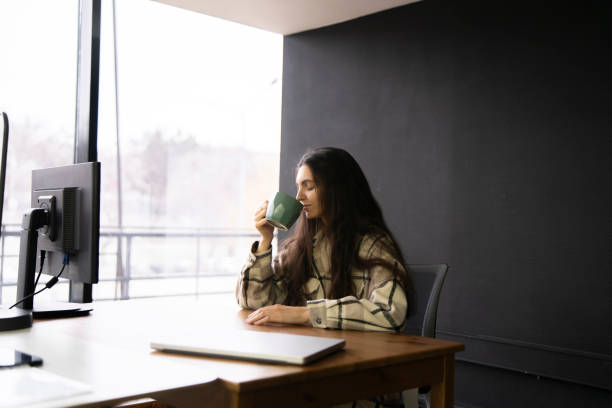 istock Office Worker Enjoying a Warm Cup of Coffee During a Break 2111071019
