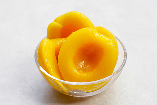 Peach halves in syrup. Fruity desserts